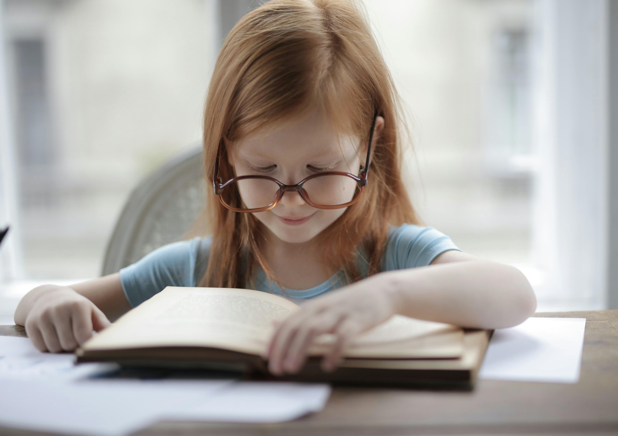 child reading book focused close up