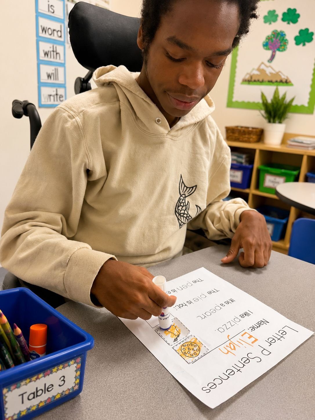 student completing a literacy worksheet in an ESE classroom