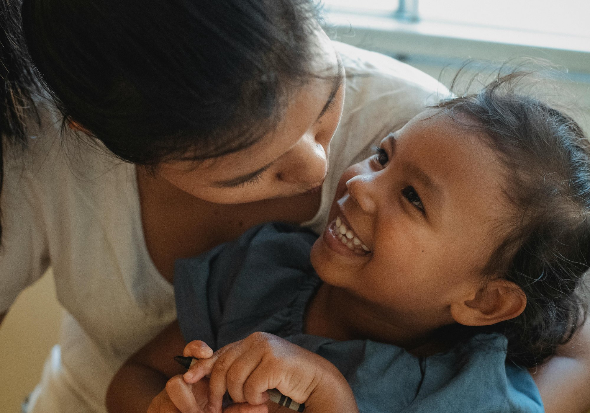happy mother hugging child smiling