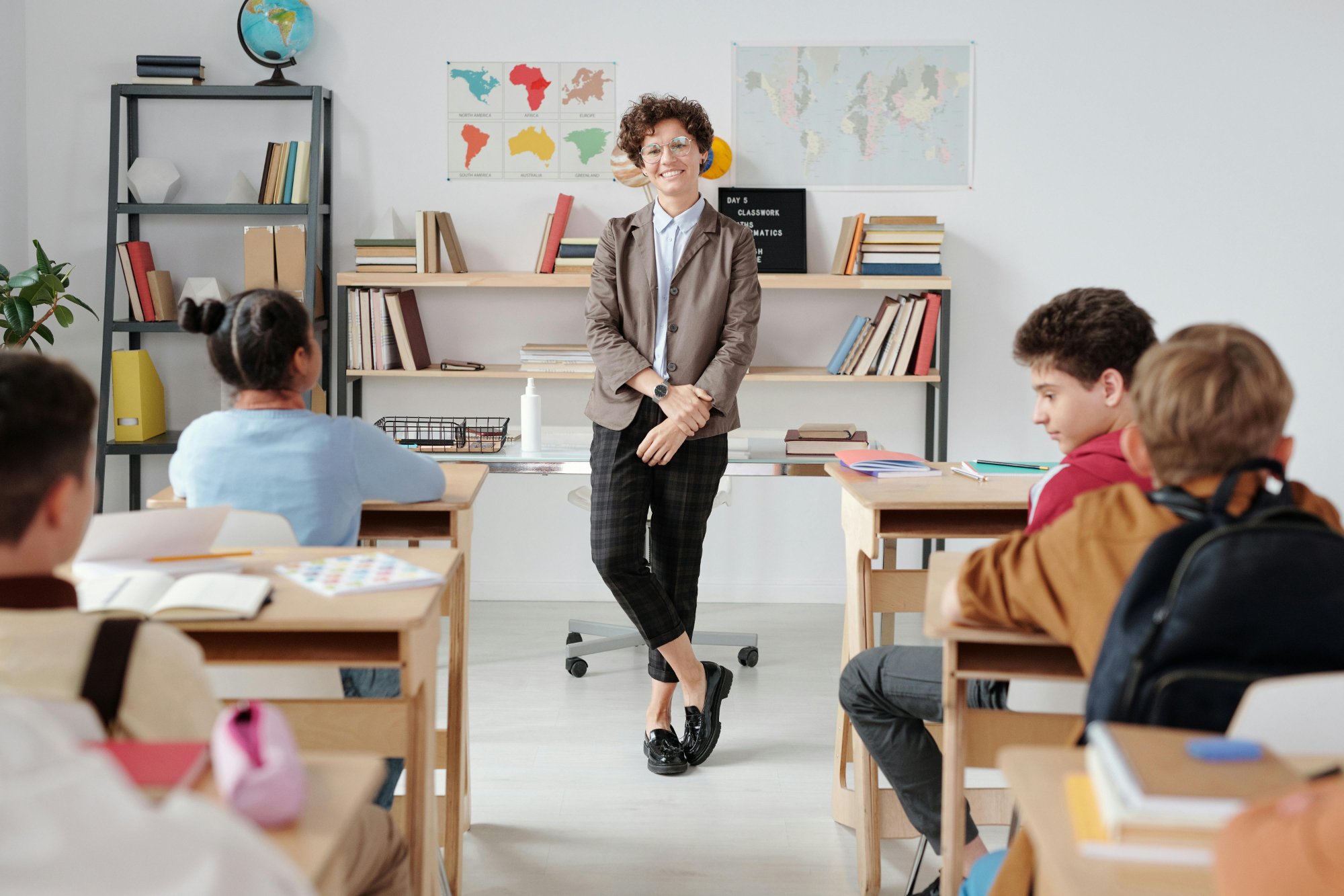 teacher smiling with young students